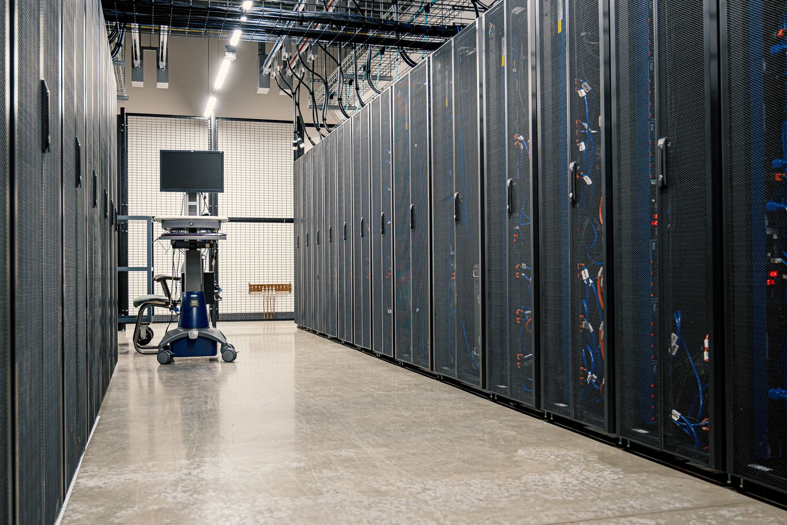 Server cabinets and overhead infrastructure in a data-centre aisle