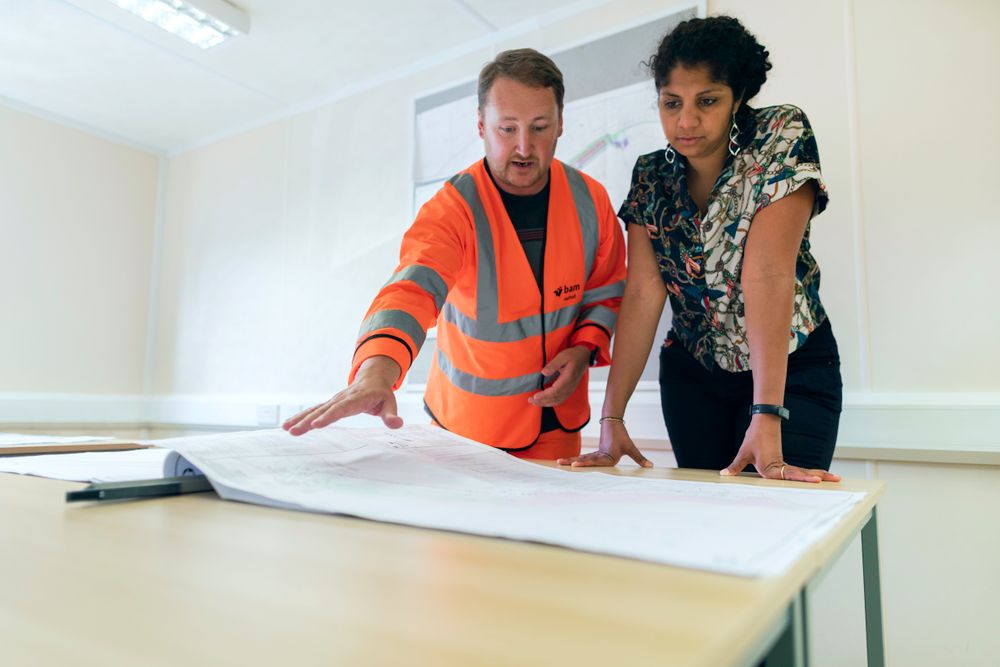 Engineers reviewing drawings together at a planning table
